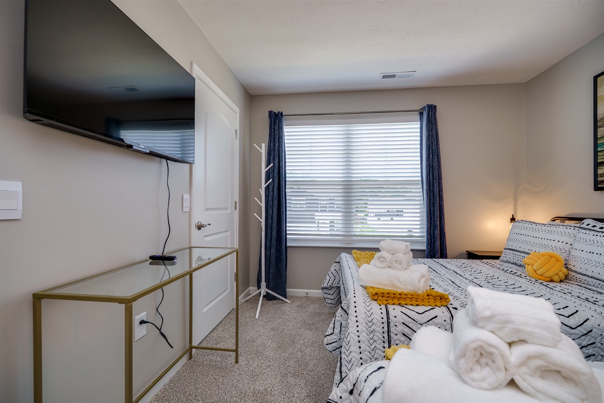 Relaxing Bedroom Featuring a Flat-Screen TV