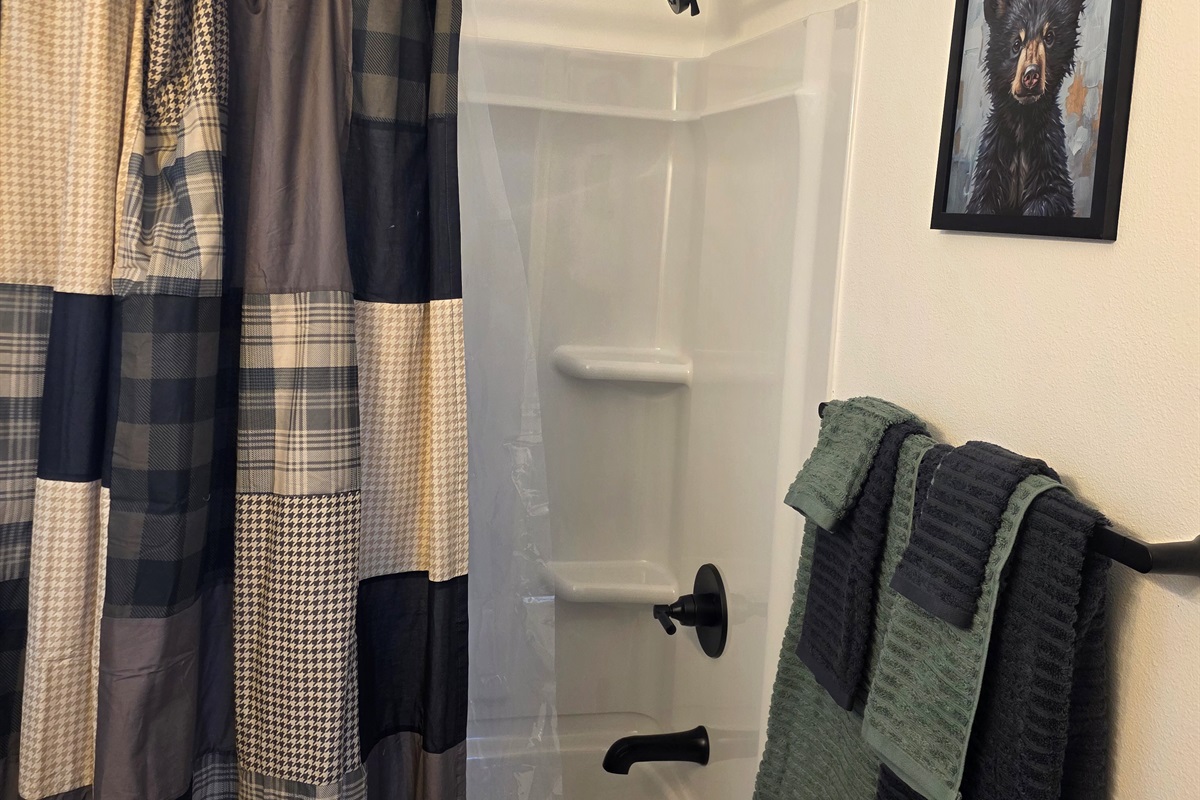 Bathroom includes a vanity, toilet, and shower/tub combo.