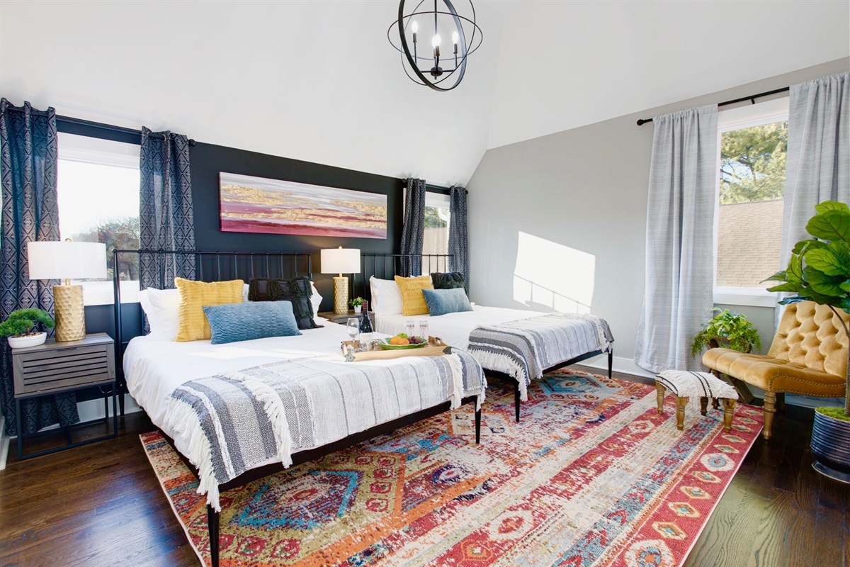 - Wake up in style with bold patterns, cozy throws, & a sun filled retreat - Two comfy beds, layered textures, & a rich vintage rug set the tone for relaxation - Perfect for friends, or couples, this colorful space feels like a getaway within a getaway