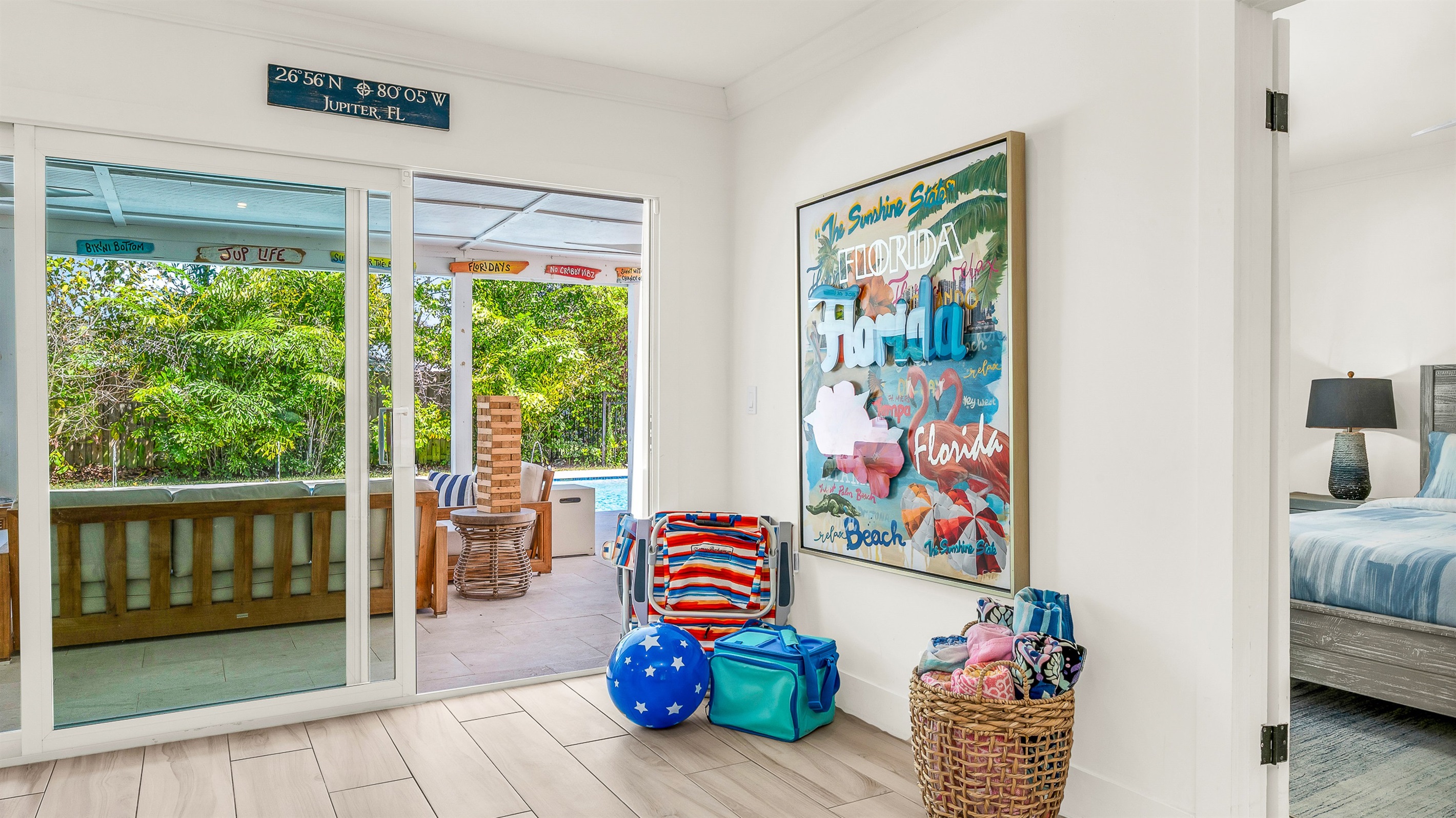 This cheerful coastal corner is thoughtfully stocked with beach essentials, ready for a day of sun and relaxation.  Bright artwork and natural textures create a welcoming vibe that perfectly complements this luxury Airbnb's laid-back seaside style.