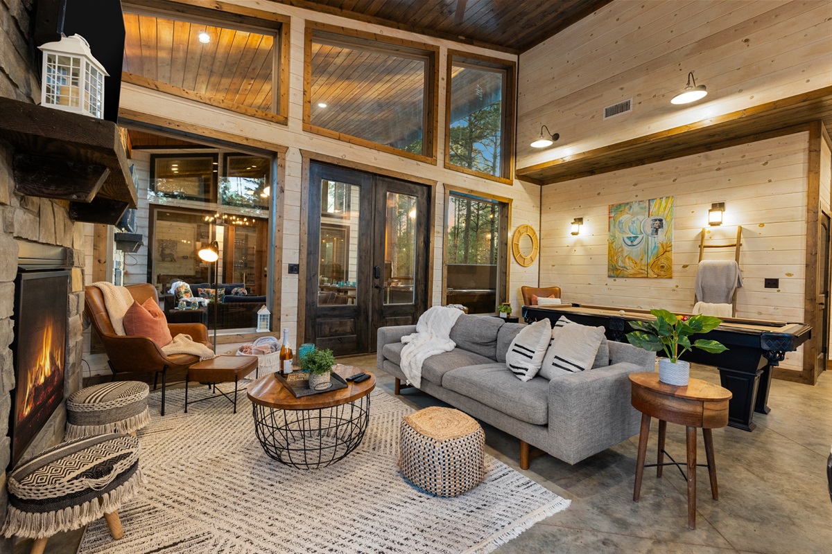 Generous ceilings and forest views give the living area an airy calm. Stretch out after a day at the lake and let the outside world slip away.