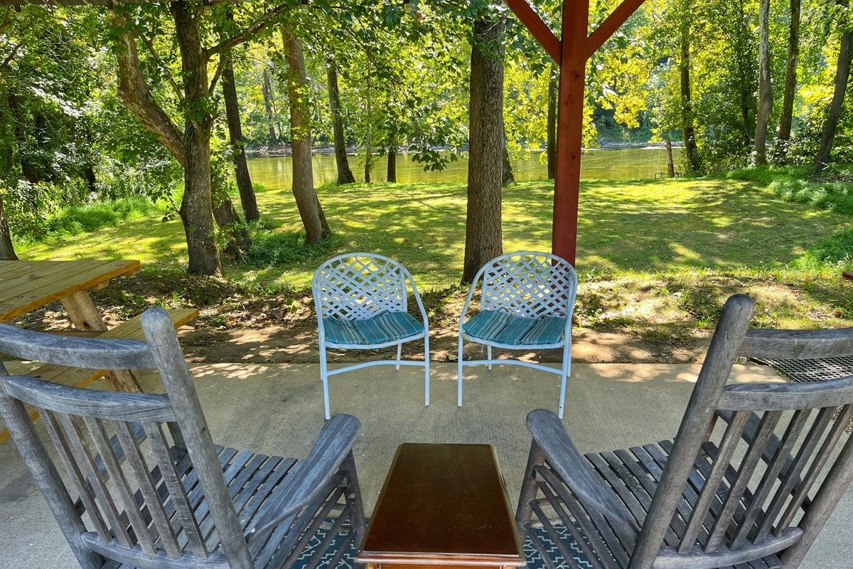Pool House table/sitting area by river