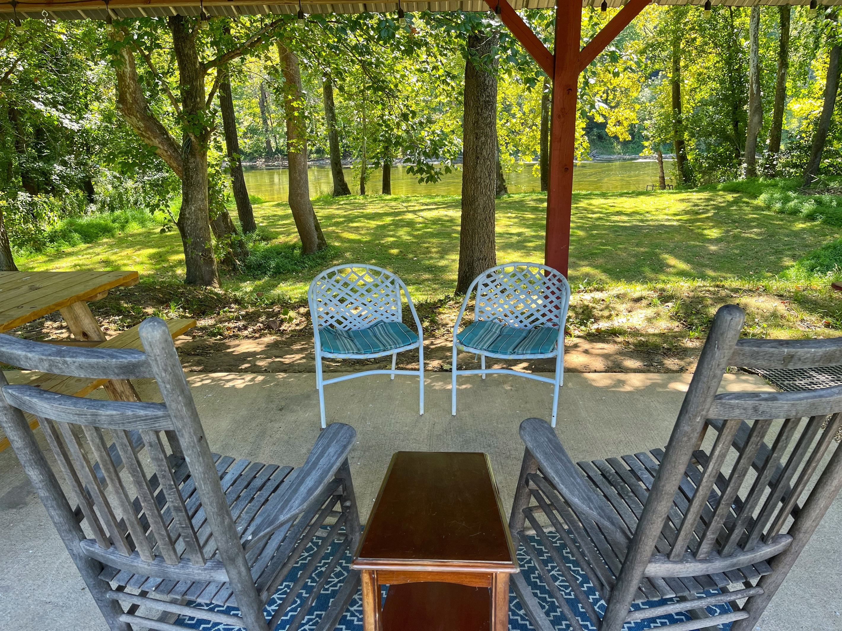 Pool House table/sitting area by river