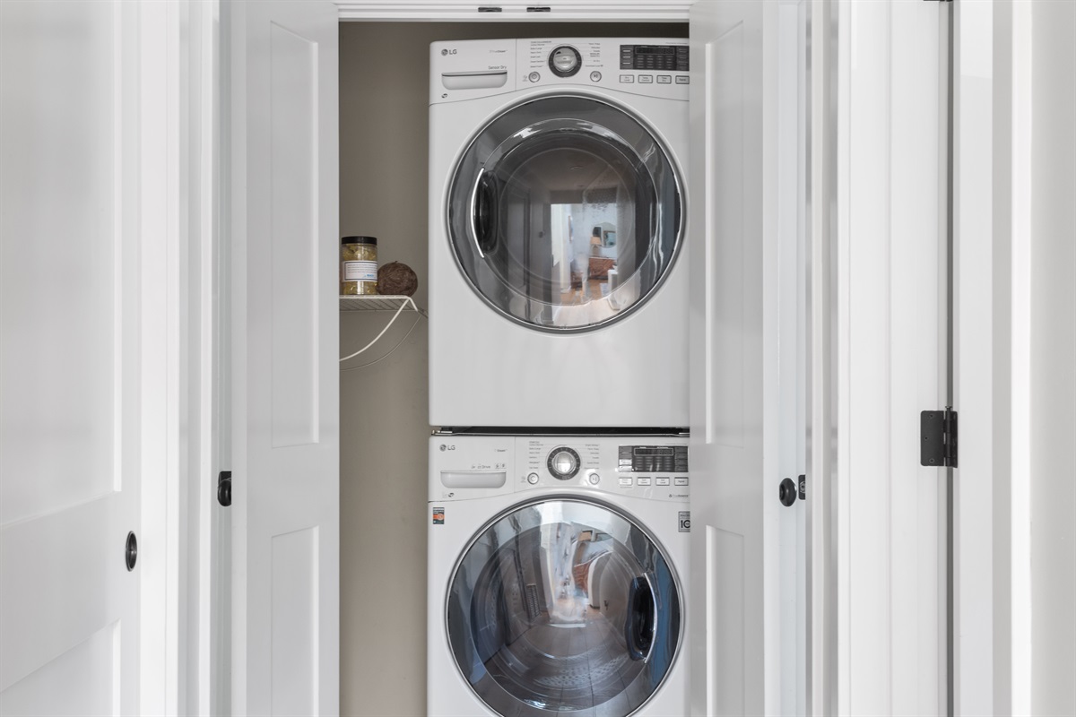 Stackable washer and dryer behind the hall doors