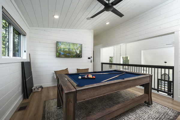 Challenge friends and family to air hockey or pool in this fun-filled upstairs game loft.