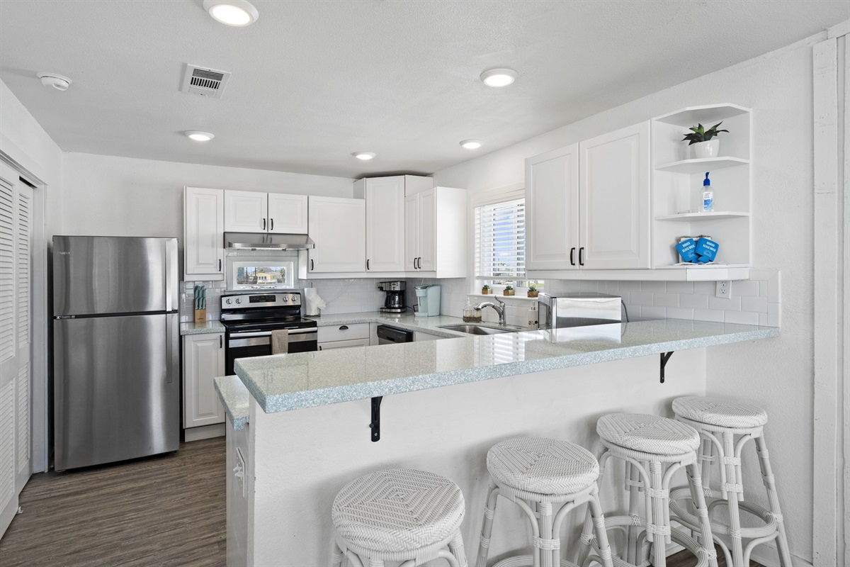 Large kitchen outfitted with high-end stainless steel appliances