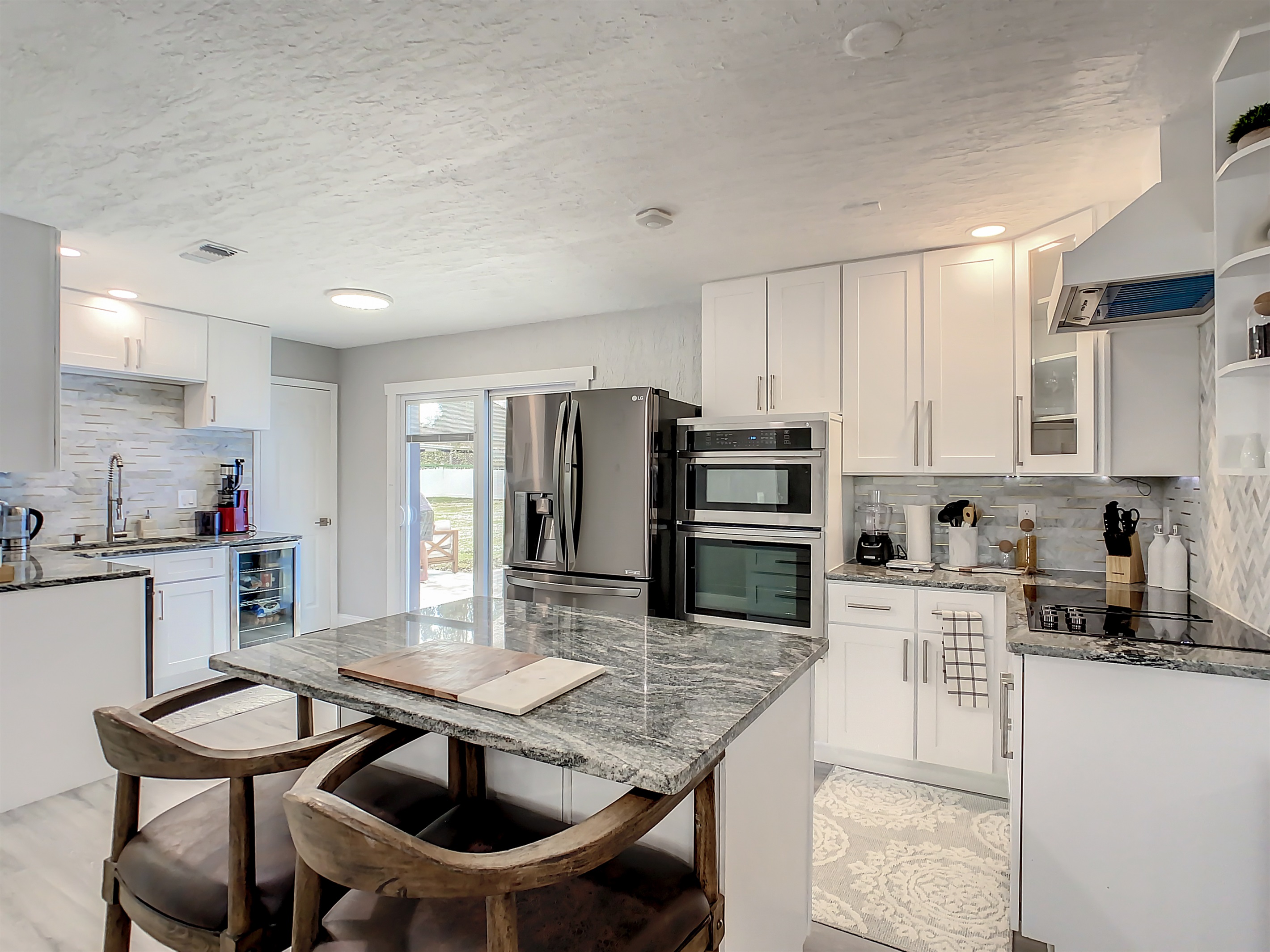 Contemporary kitchen with granite island, stainless steel appliances, and ample cabinet space.