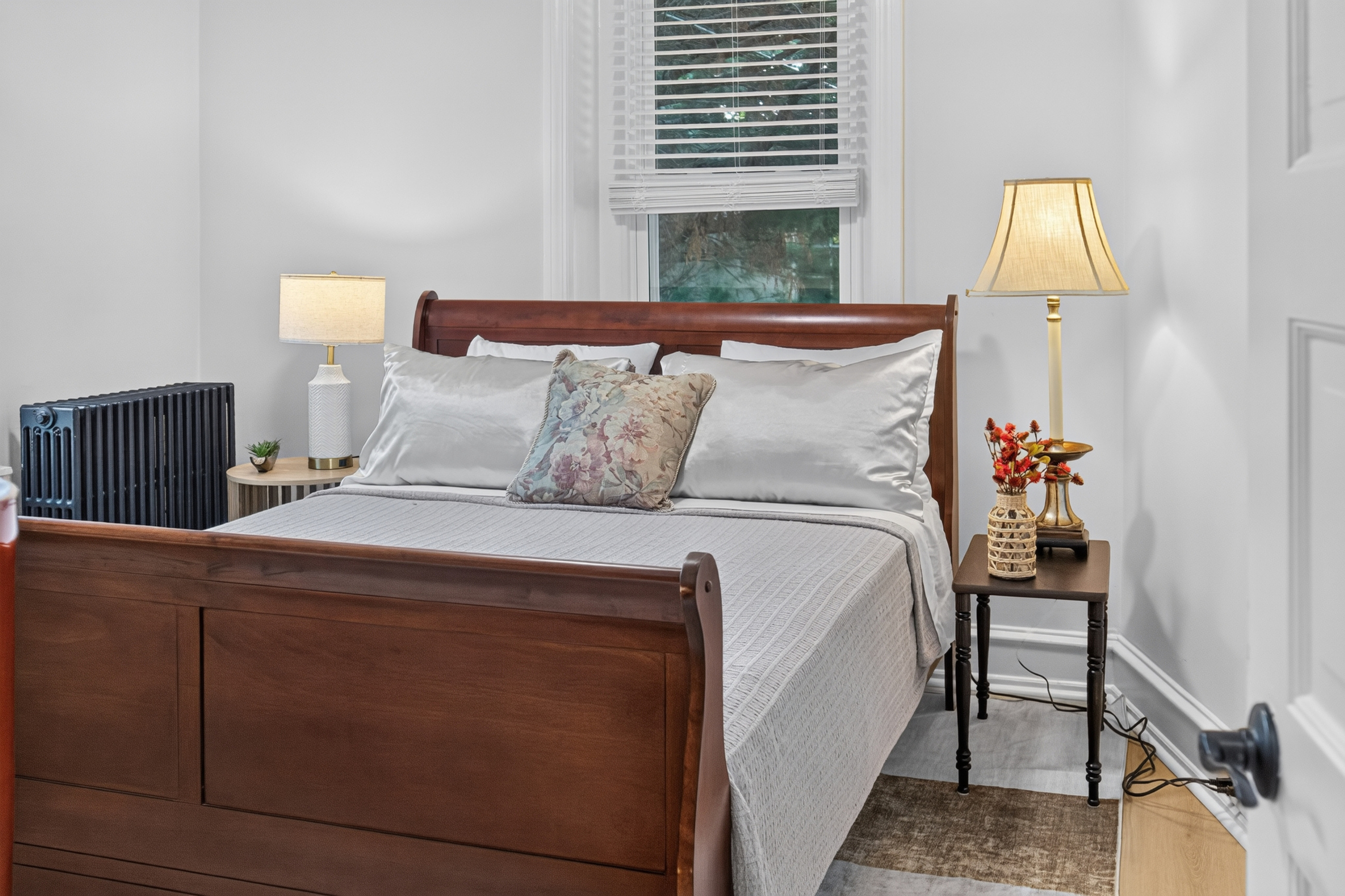Second private bedroom featuring a Queen sleigh bed, bedside reading lamps, and USB charging.
