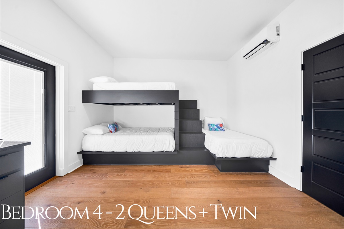 A spacious bunk room featuring two queen beds and a twin, providing plenty of flexibility for families or groups while maintaining a cozy and stylish feel.