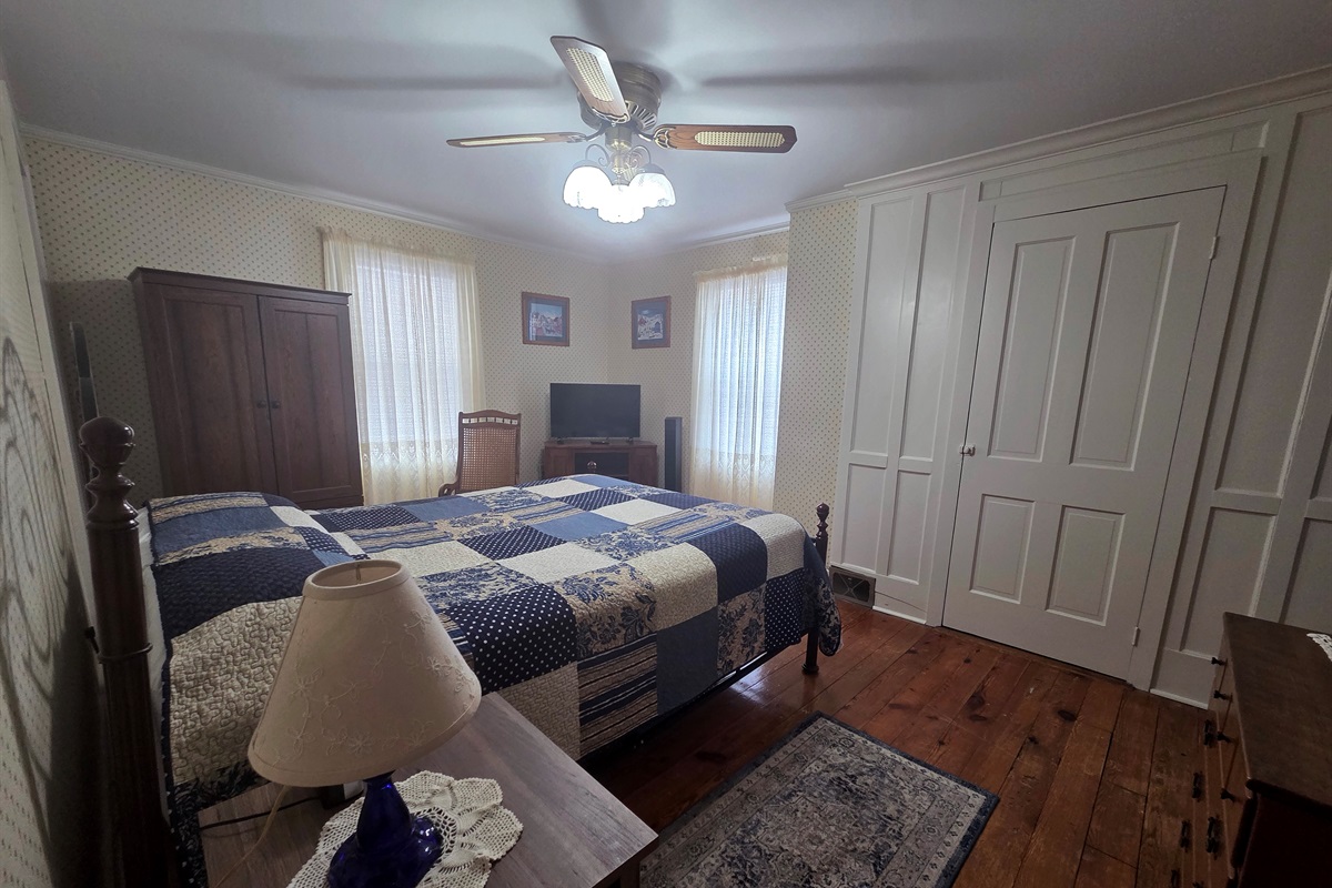 The Master bedroom upstairs features a comfortable queen bed.