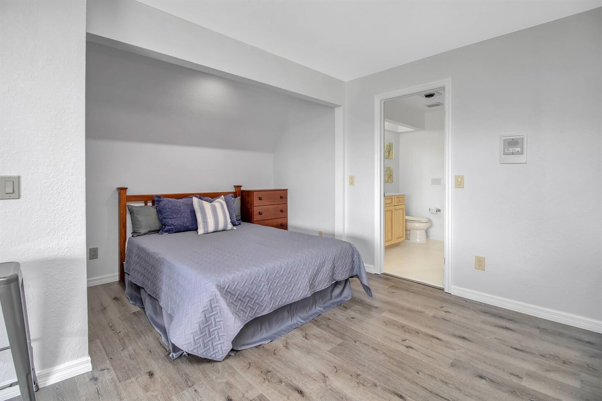 Queen bed with dresser & direct access to the bathroom.