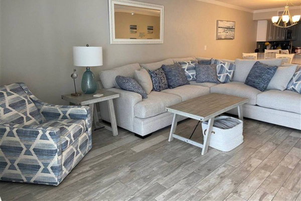 sectional in living room with ocean and beach views.