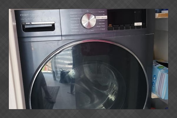Full size washing machine in the common area shared with upstairs apartment