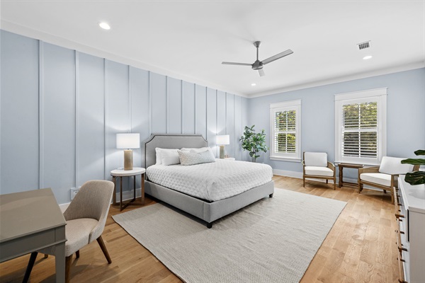 Start and end your day in this calm bedroom complete with seating area, desk, and HDTV