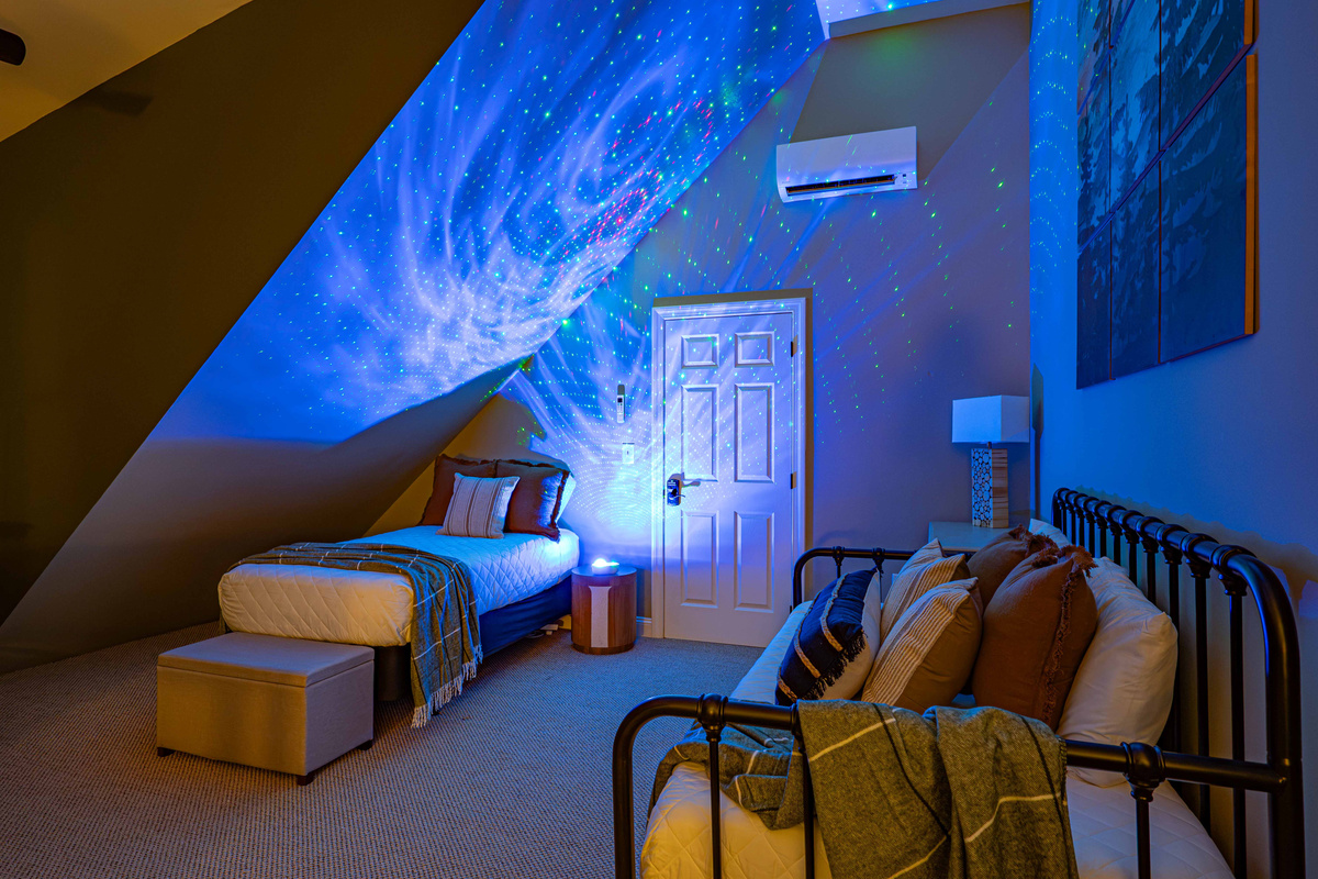 Drift off under the stars with the galaxy projector lighting up the loft.