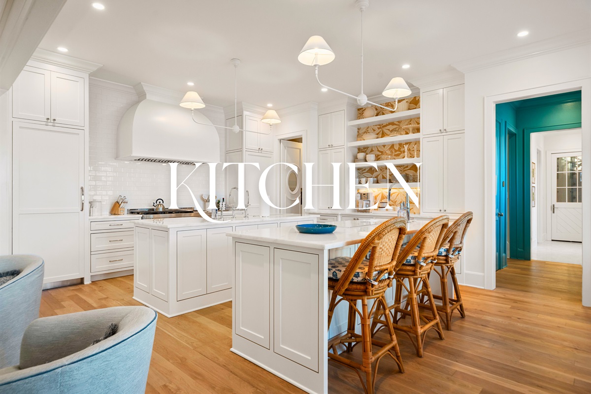Open kitchen with island seating and modern pendant lighting.
