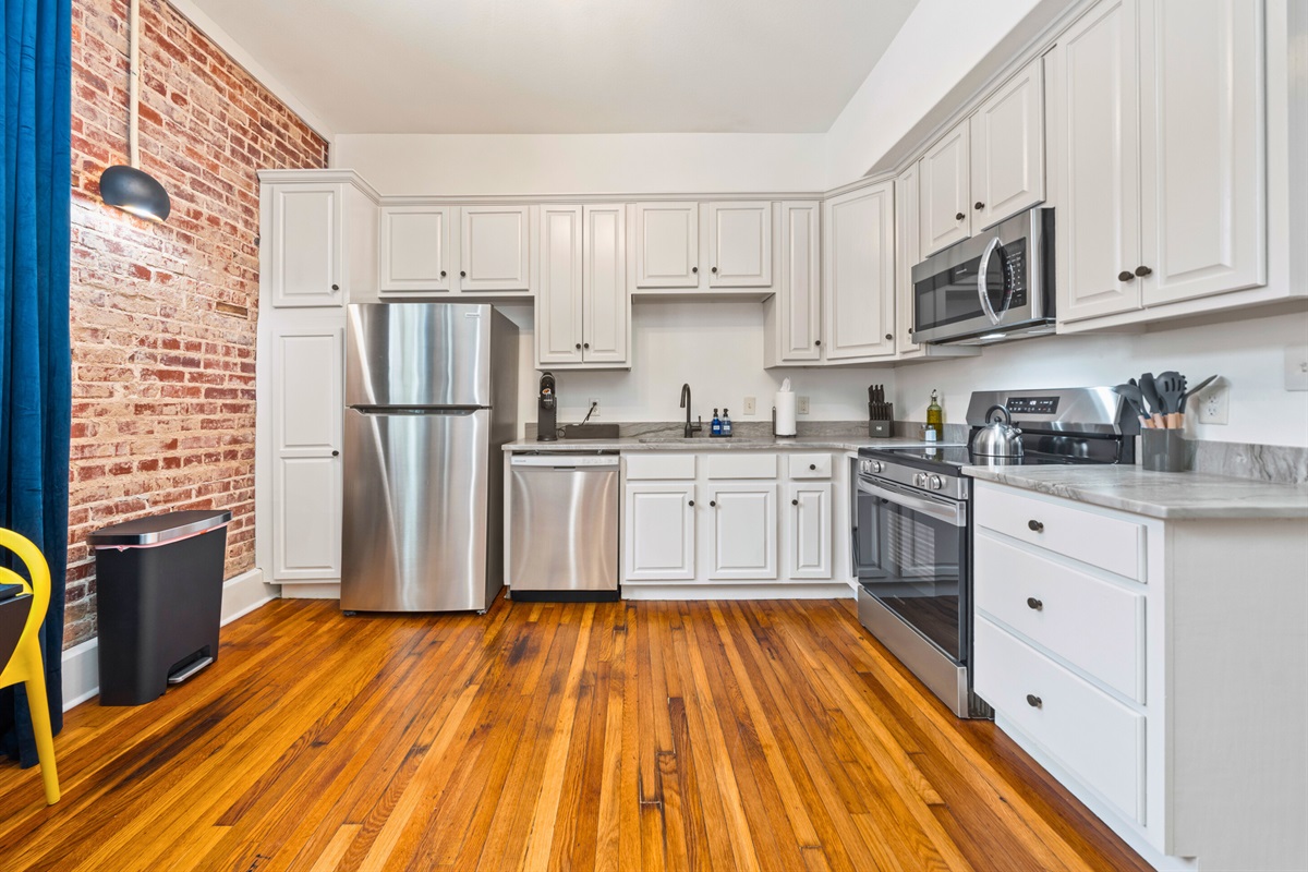 A fully equipped kitchen with stainless steel appliances and plenty of counter space, perfect for preparing meals or snacks during your stay.