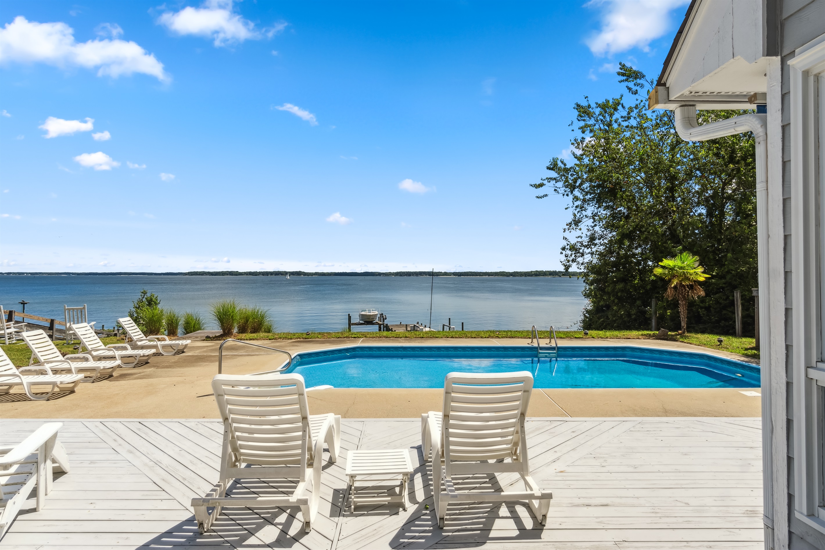 Relax poolside with lounge chairs, a sparkling pool, and beautiful waterfront views.
