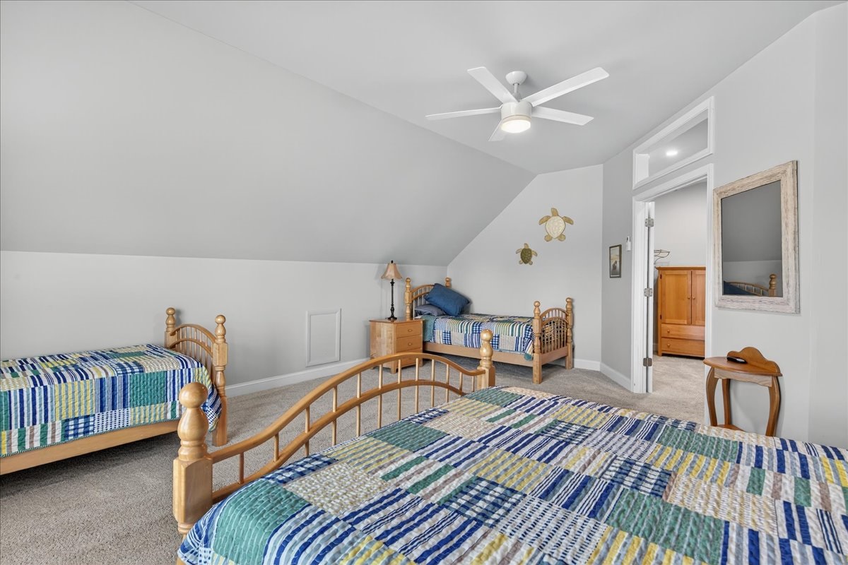 Family-friendly bedroom with multiple beds and separate enclave with crib for little ones.