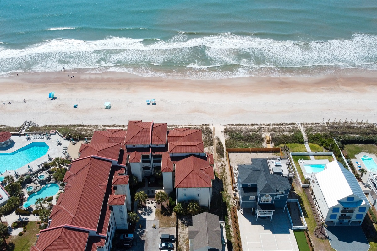 Coastal community stretches along a pristine beach