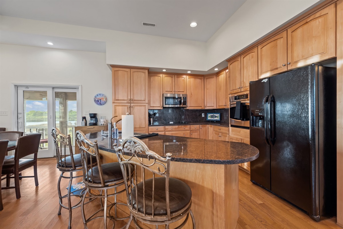 Fully equipped kitchen with spacious island seating&mdash;perfect for cooking, gathering, and entertaining your group
