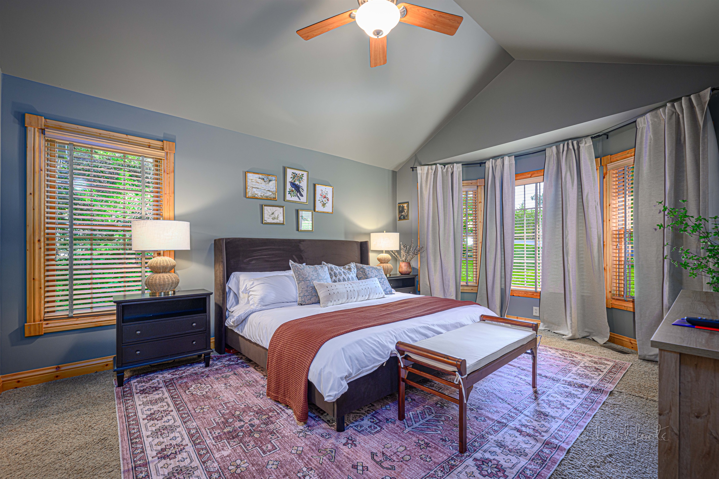 Primary bedroom on main floor includes king bed, walk in closet, Roku TV, and en suite bathroom