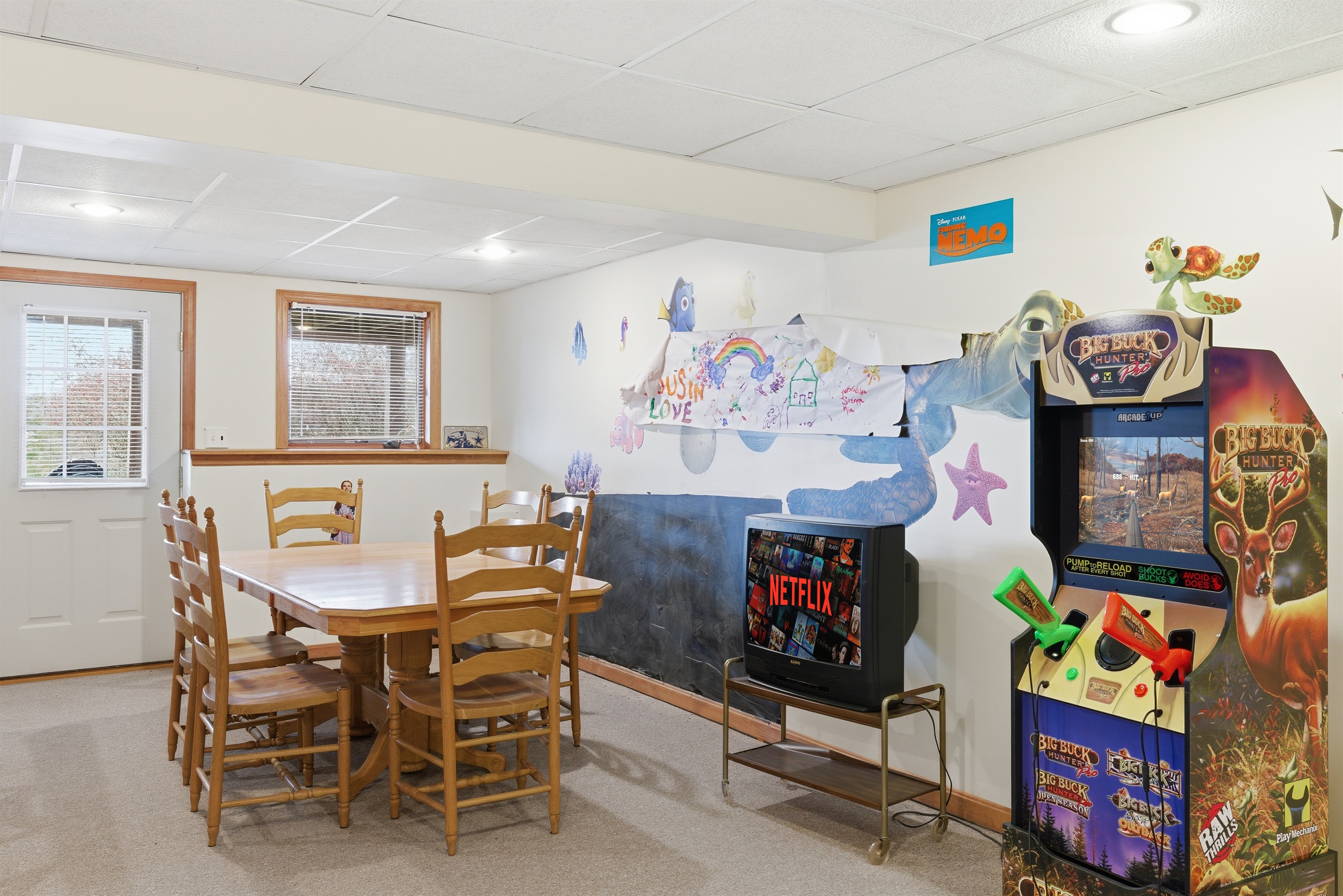 Playroom for kids and adults.  Air hockey, stereo system, toys, arcade, seating area.