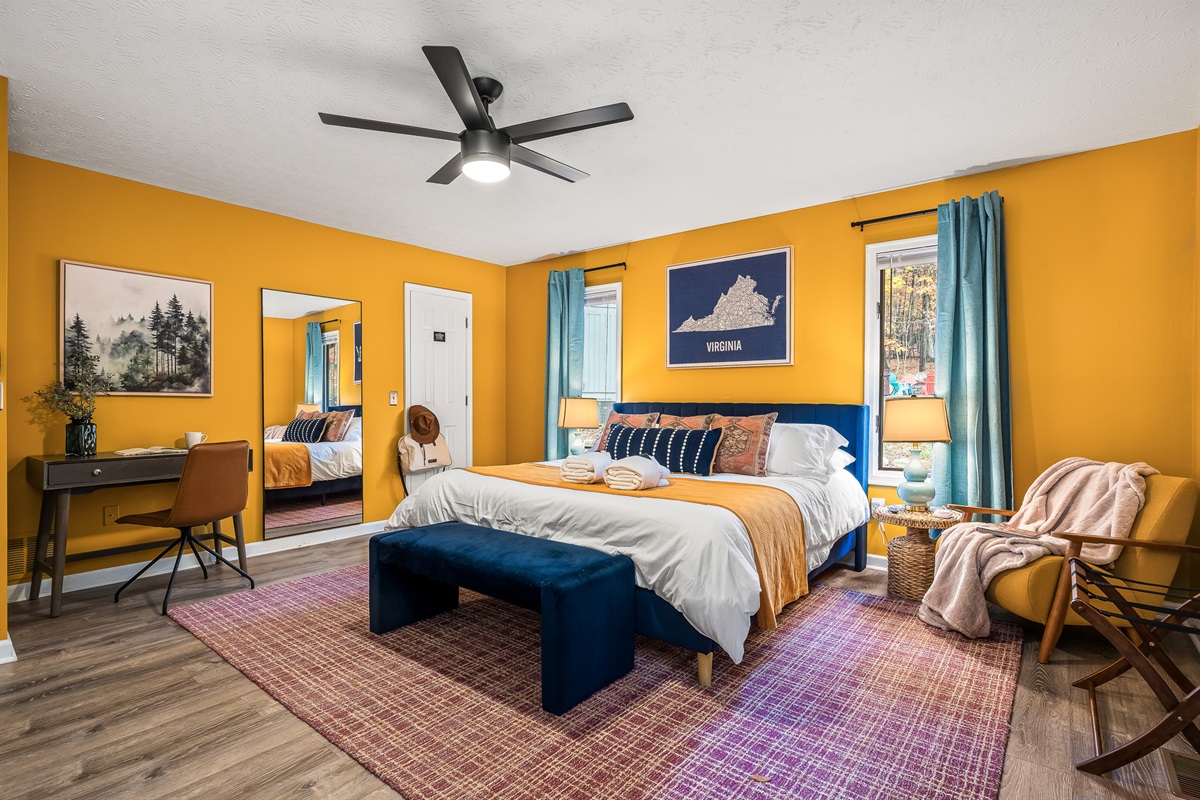 Primary king bedroom with work desk and blackout curtains