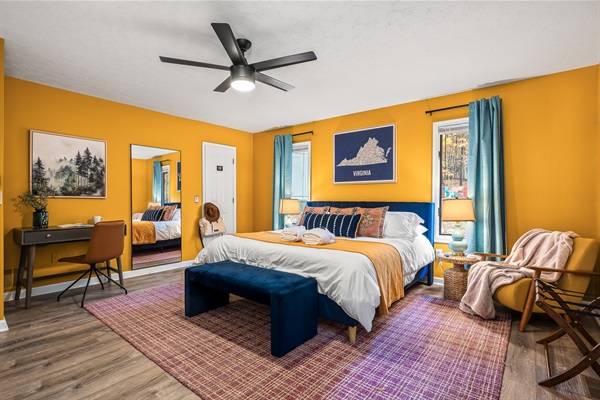 Primary king bedroom with work desk and blackout curtains