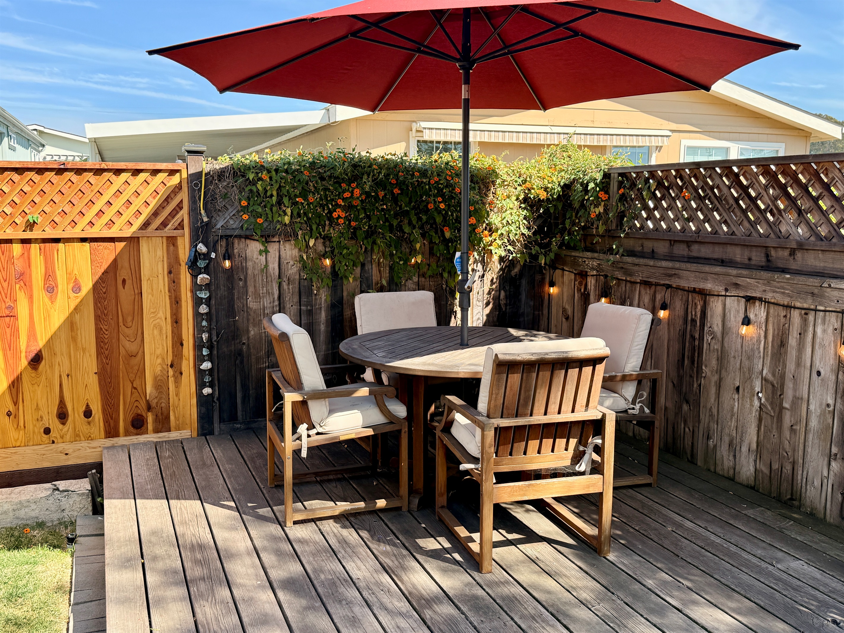 Dining on the back deck! Outdoor deck includes BBQ with tools, 2 chaise lounge chairs, a teak dining table with 4 chairs, and 2 camping rocker chairs (stored in garage).