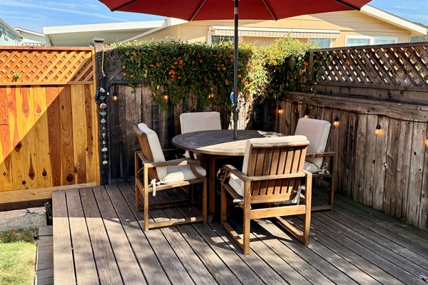 Dining on the back deck! Outdoor deck includes BBQ with tools, 2 chaise lounge chairs, a teak dining table with 4 chairs, and 2 camping rocker chairs (stored in garage).
