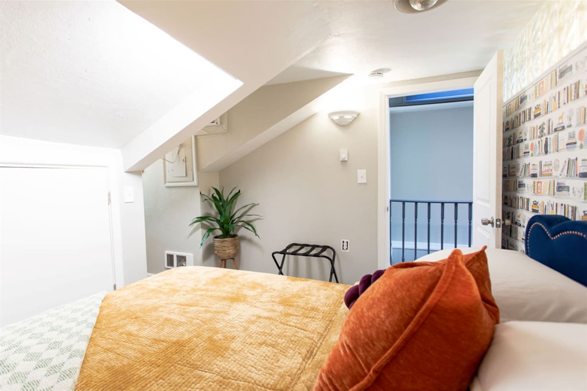 Cozy queen bedroom with bright accents, creating a cheerful and inviting atmosphere.