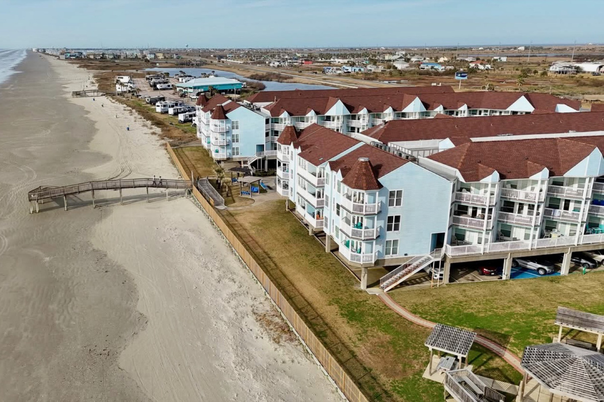 Galveston’s West End gem—resort-style complex nestled along the shoreline with palm-lined pools and pristine beachfront views.
