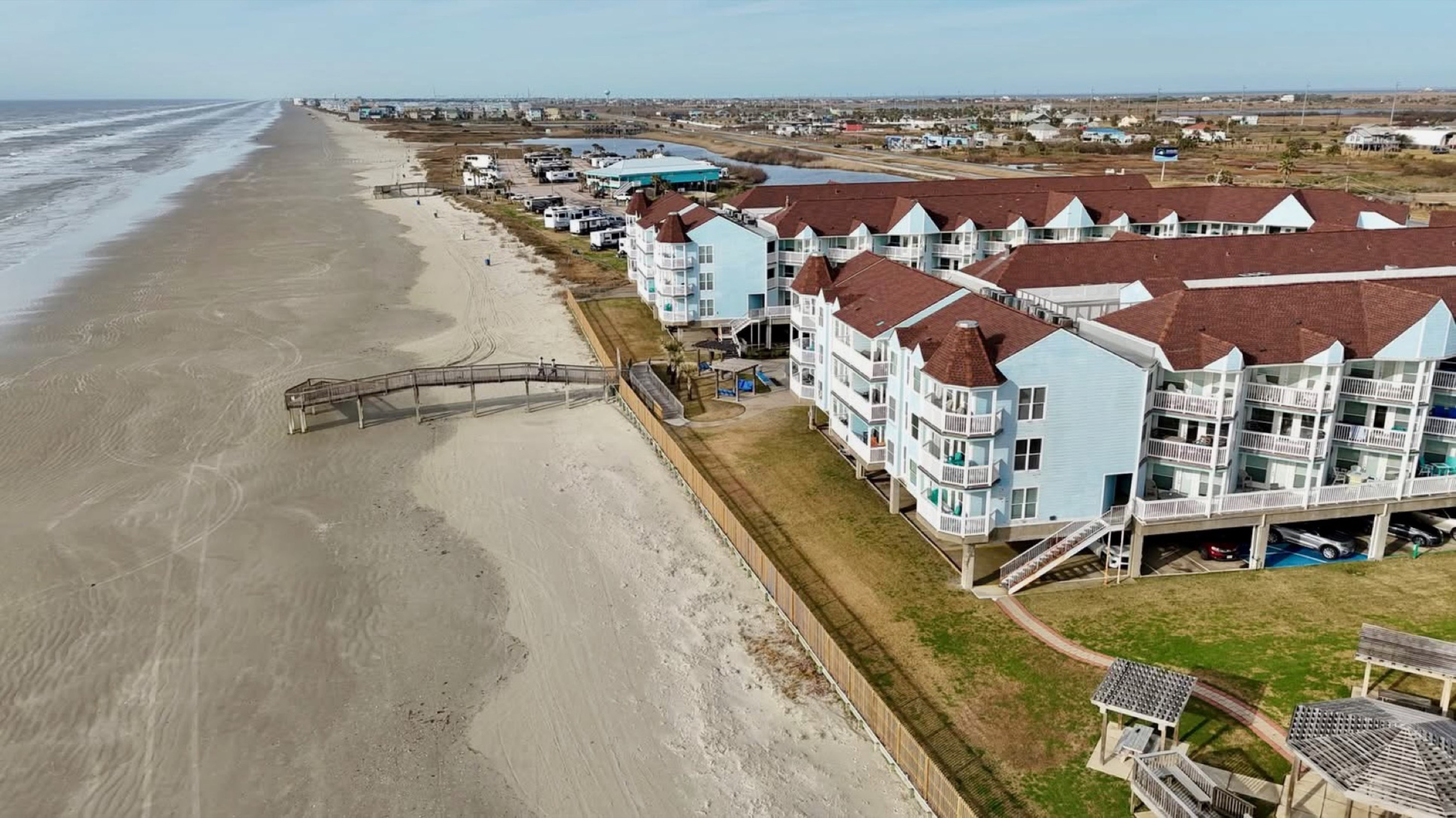Galveston’s West End gem—resort-style complex nestled along the shoreline with palm-lined pools and pristine beachfront views.