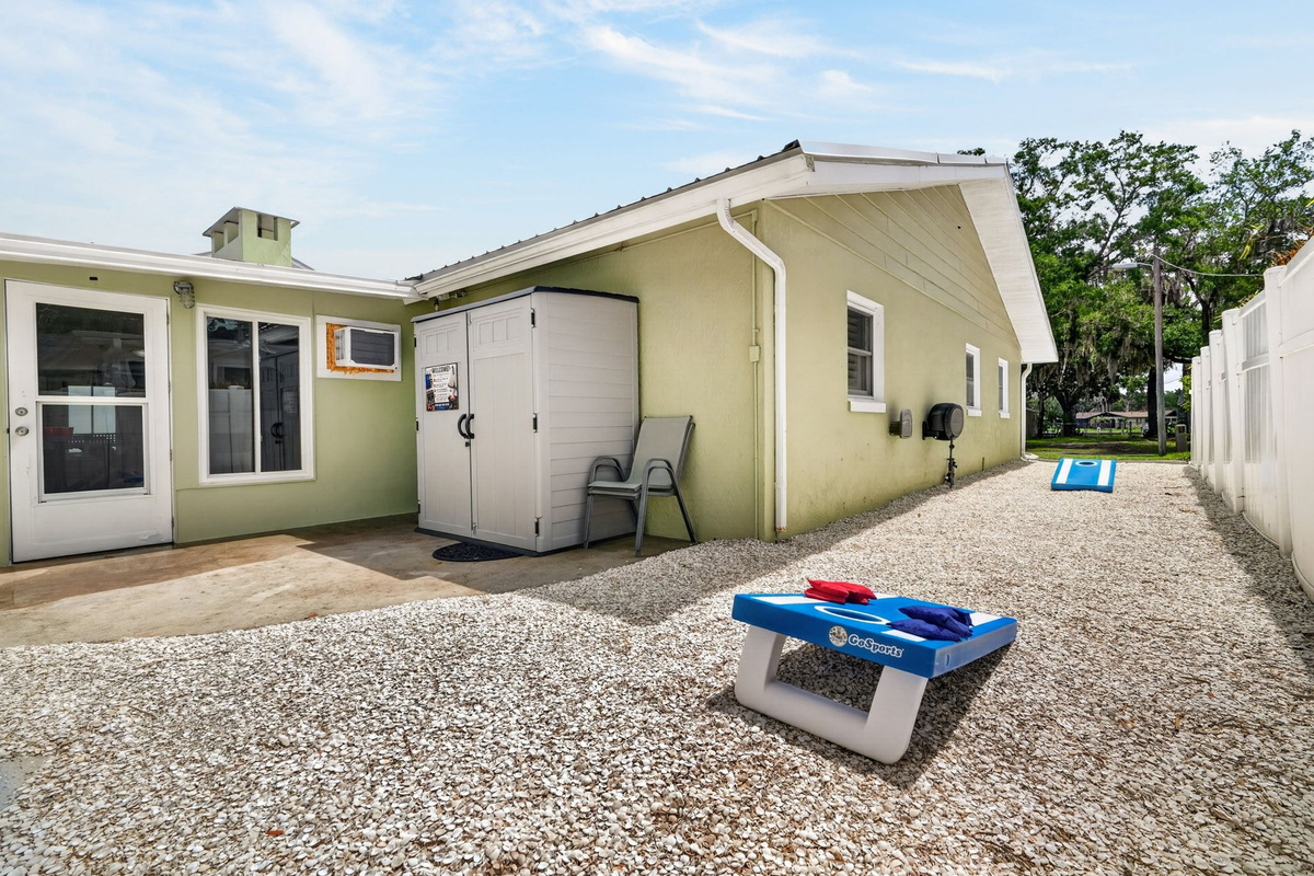 Storage shed exterior with cornhole boards