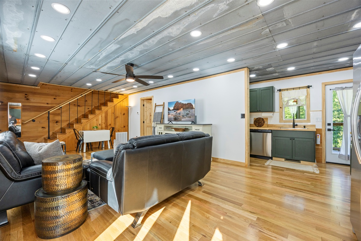 Alternate view of the living room showing the open layout flowing into the kitchen.