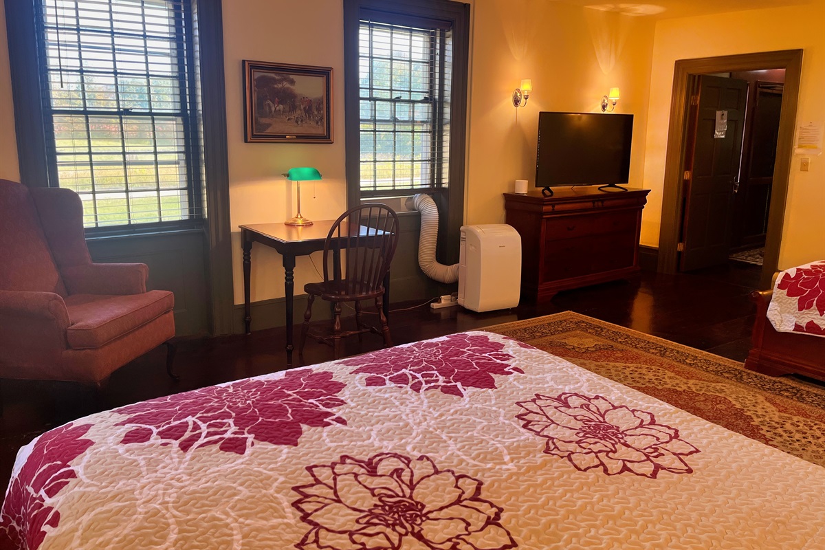 Guest room #4 with large Roku TV and sitting area.