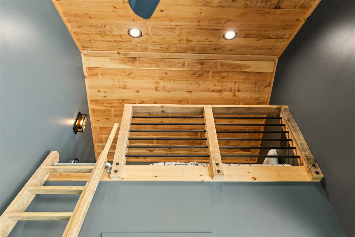 A loft space with warm wooden accents and additional sleeping accommodations for your group.