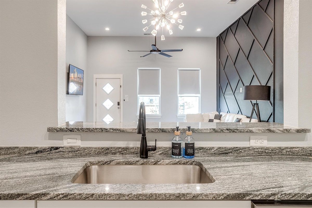 Open layout connecting kitchen, dining, and living for seamless hosting.