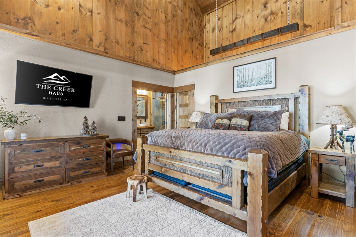 Experience rustic elegance in this king bedroom, featuring warm wood accents, a handcrafted bed, and a cozy atmosphere for ultimate relaxation.