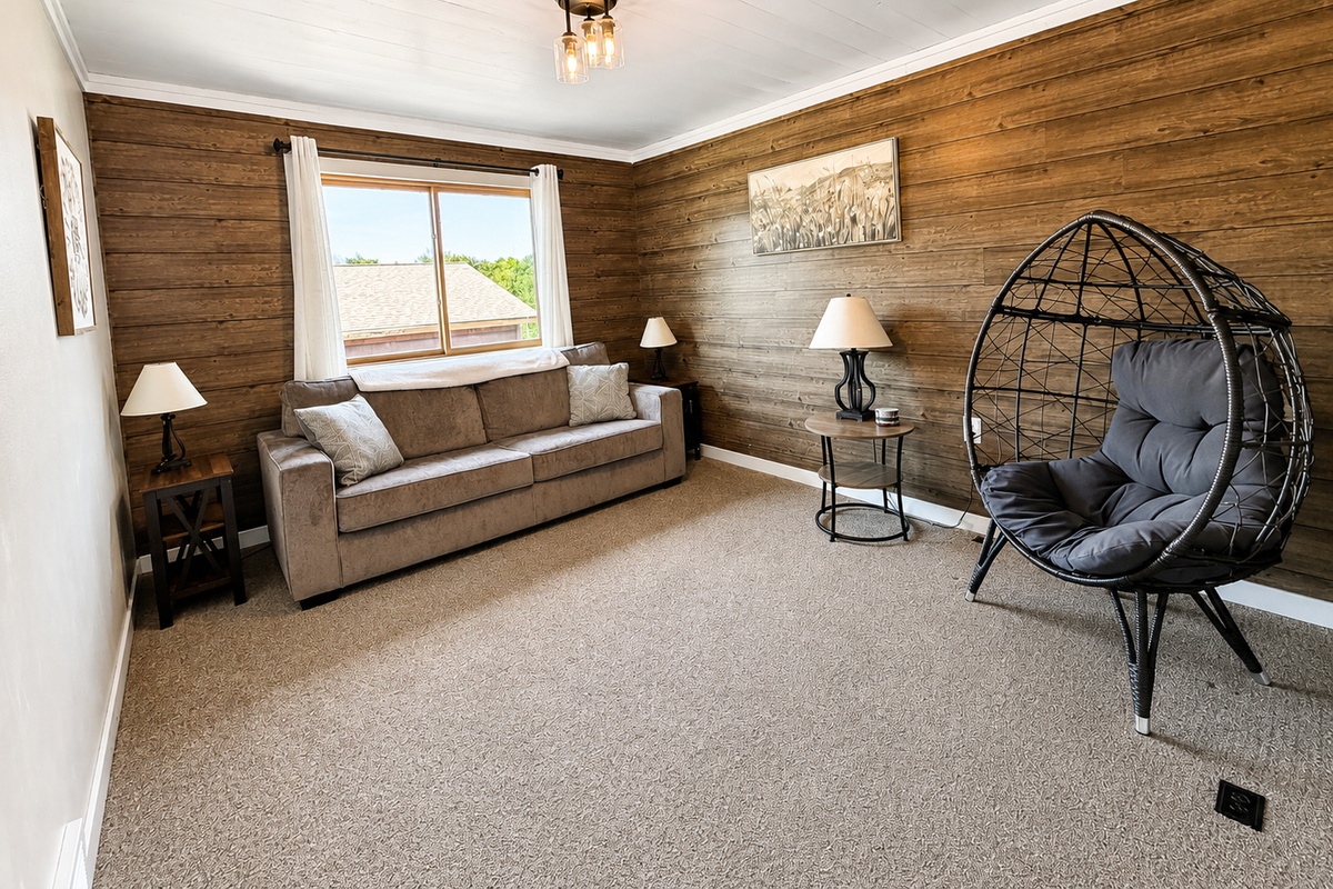 At the top of the steps separate sitting room with comfortable seating and a hanging chair gives guests another relaxing space to spread out.
