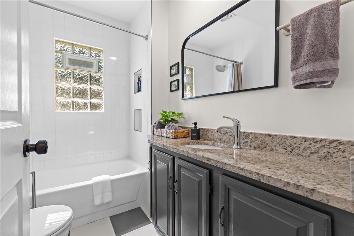 Modern bathroom with granite countertop and sleek finishes