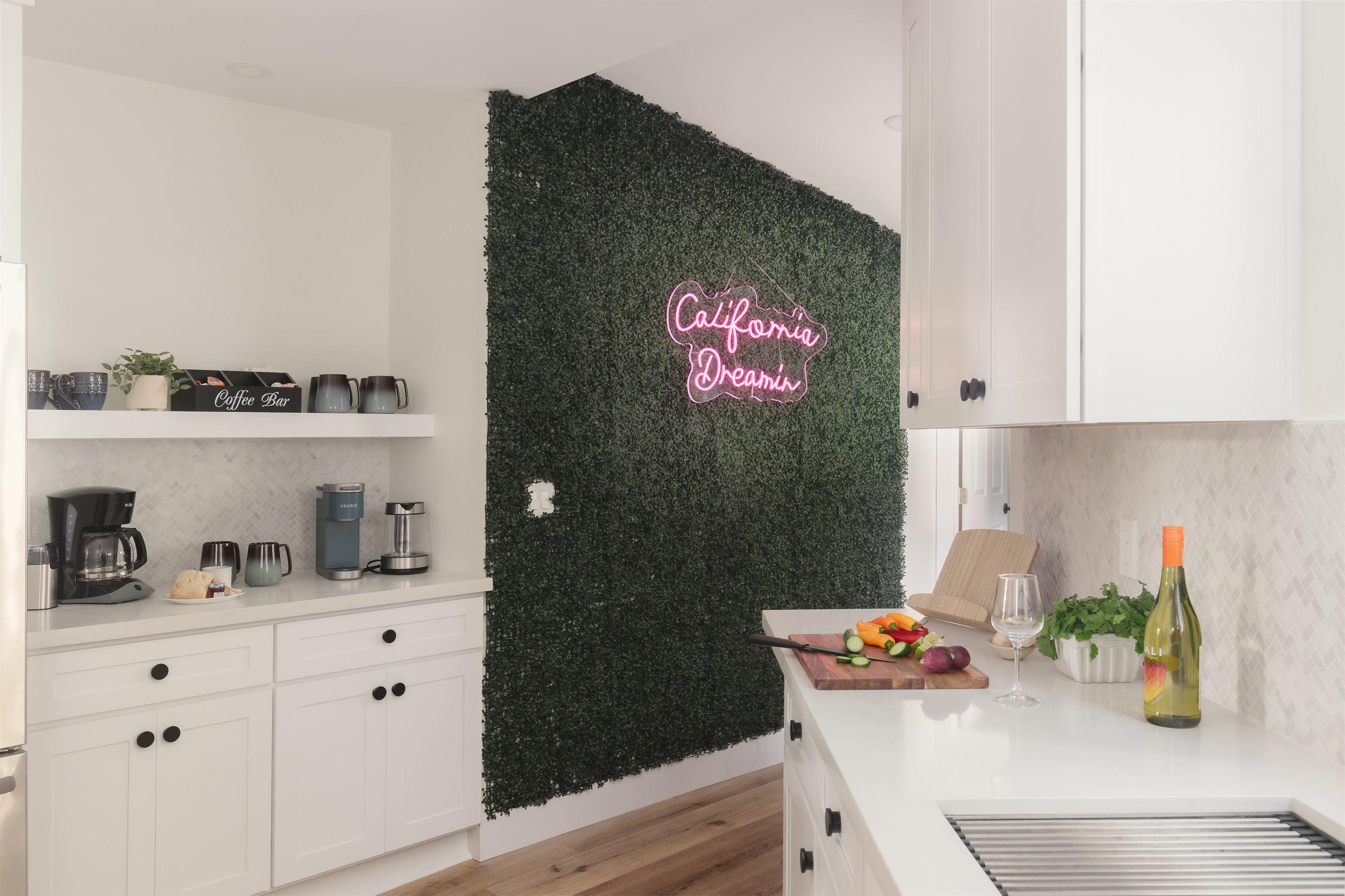 Where meals are made and memories begin 💕✨ Families love gathering in this bright kitchen, complete with our signature green wall and ‘California Dreamin’’ neon sign, bringing a playful pop to your stay