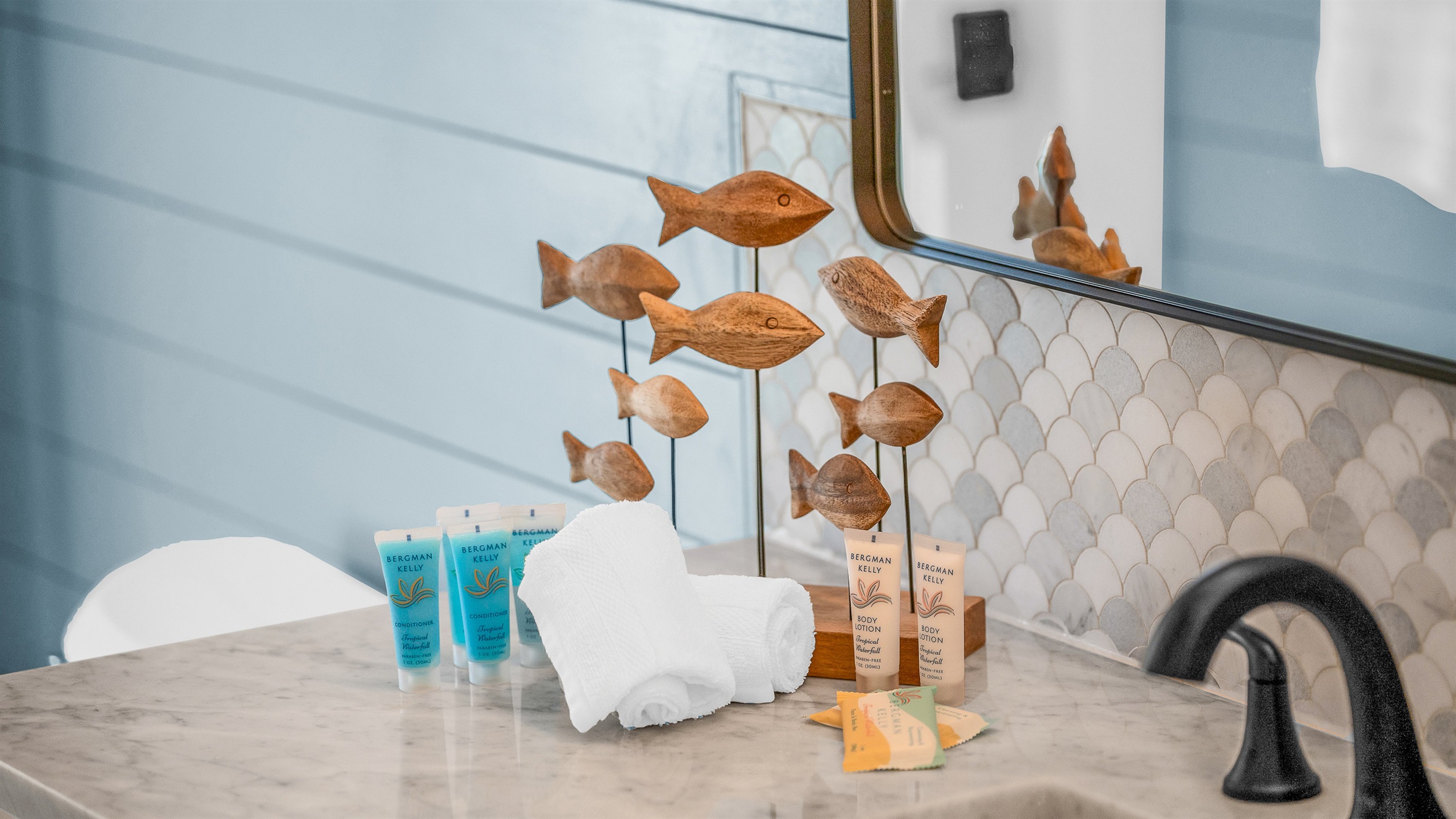 The second bathroom combines coastal charm with modern style, featuring blue shiplap walls, matt black fixtures, and a bright, airy design that brings a refreshing spa-like feel to the space