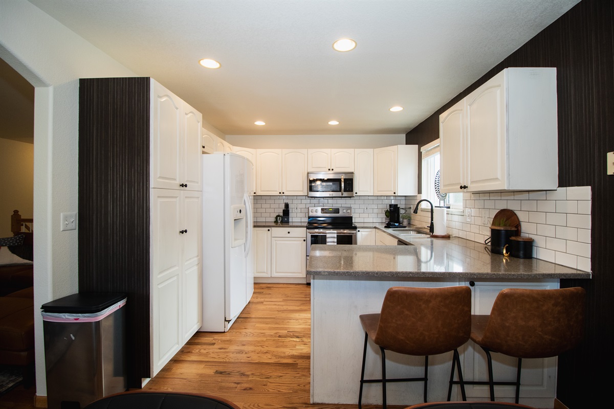 Warm kitchen stocked with coffee, flour, spices, cooking oil, and all of the essentials! All you need are the groceries.