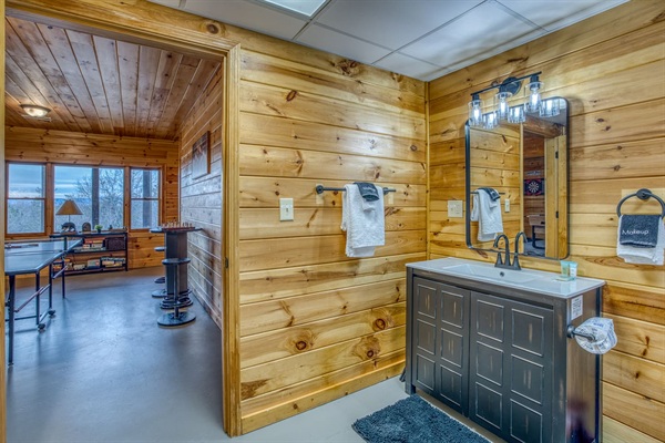 Full bathroom in the basement with sink, toilet and tub - right off the game room!