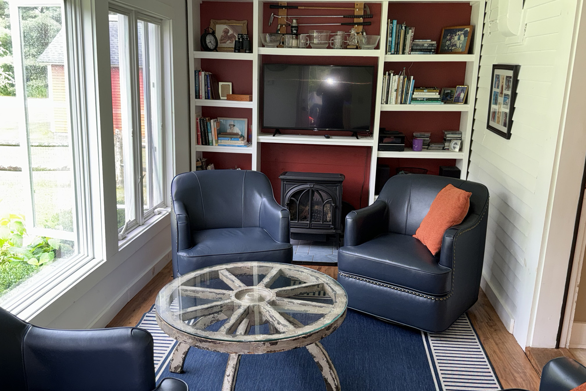 Cozy sunroom with comfortable seating and TV