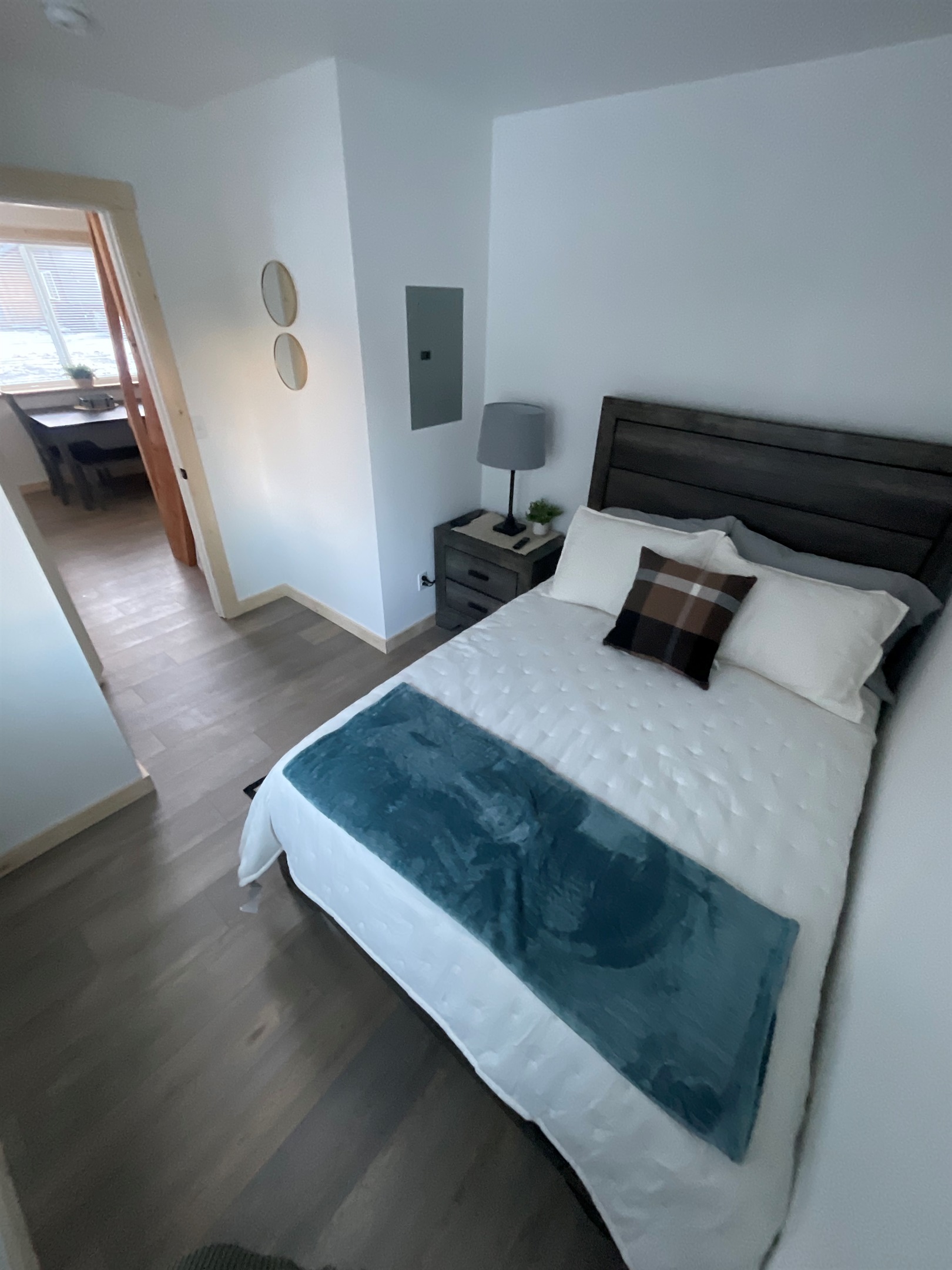 Bedroom on main floor includes a Queen Size Bed with night stand, closet space, and TV. [Photo is representative but may not be from this cabin].