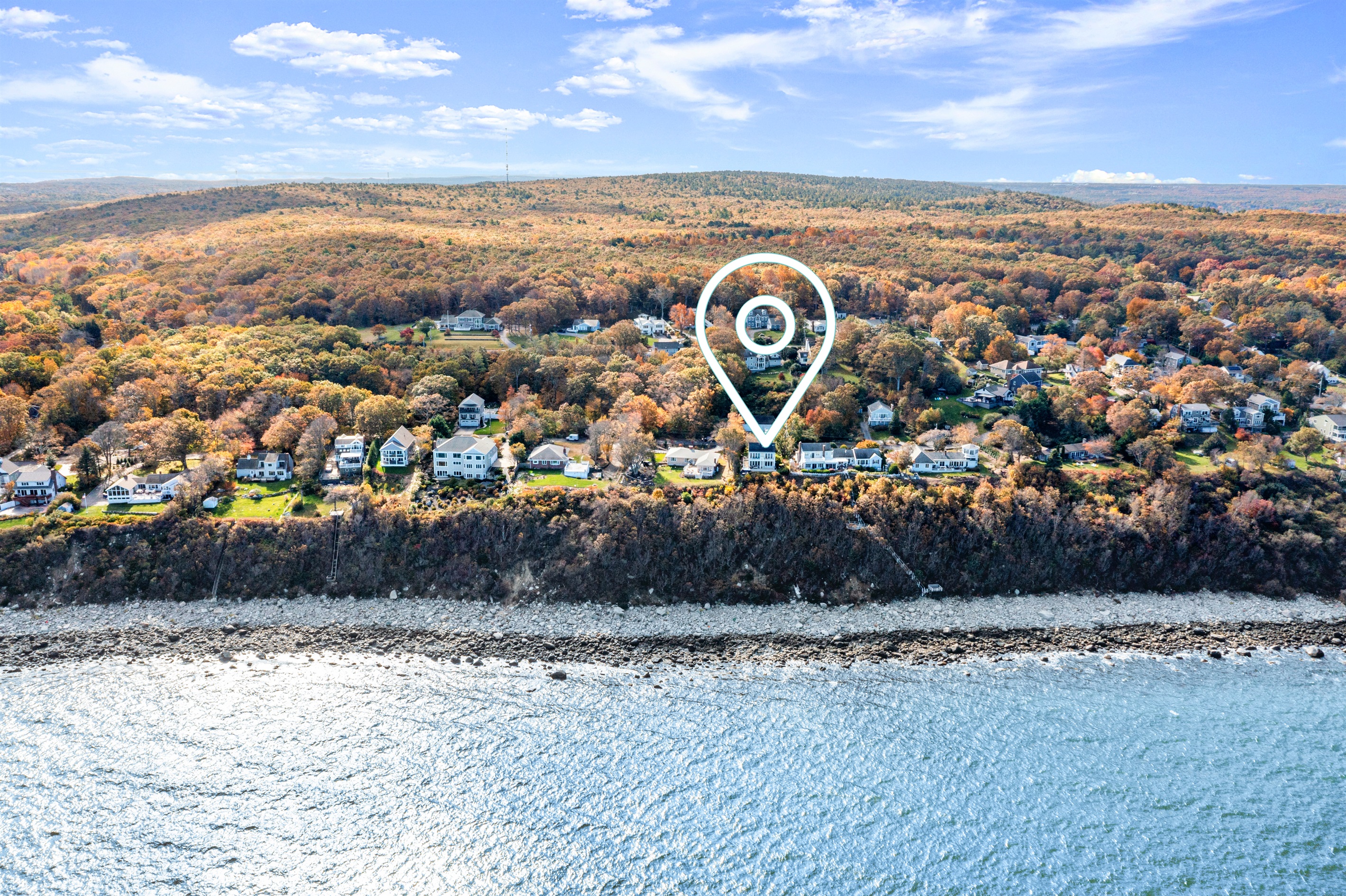 Bird’s-eye view showcasing the house and sparkling coastal waters