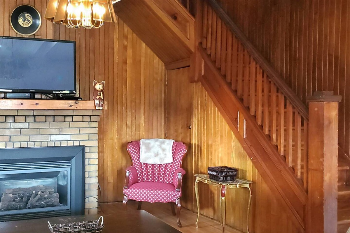 Living room with gas fireplace and stairs to bedrooms upstairs
